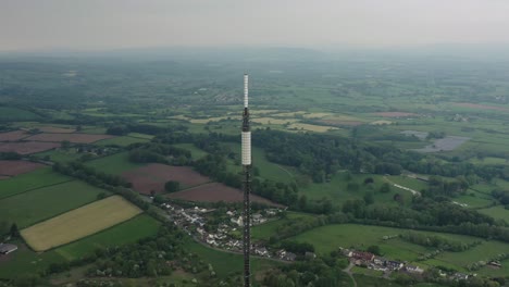 orbiting aerial shot circling the tip of a television broadcast station antenna mast overlooking the vale of glamorgan in cardiff south wales