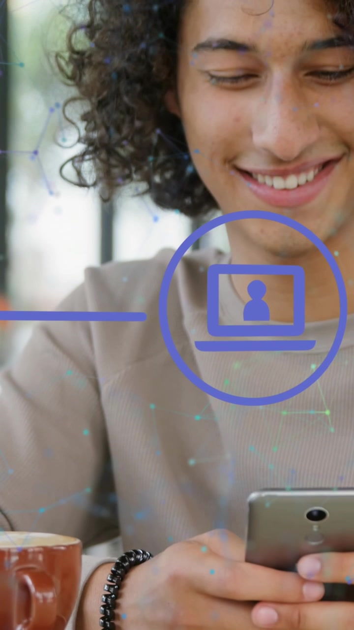 Animation of icons in circles and connected dots over smiling young man using cellphone