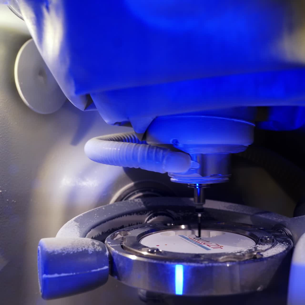 Dental milling machine carving out shape. Close up works of the dental milling machine processing of carving out shape of human teeth from dental milling machine