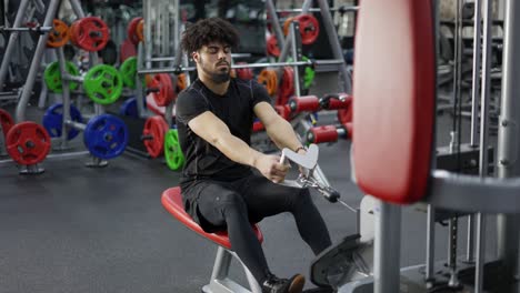 Intensive-workout-in-gym,-man-doing-cable-row-exercise,-slow-motion