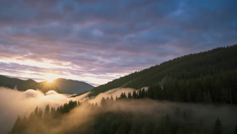 sunrise over misty mountain valley with forest