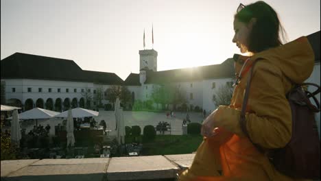 young woman digital nomad looking at ljubljana castle square in slovenia