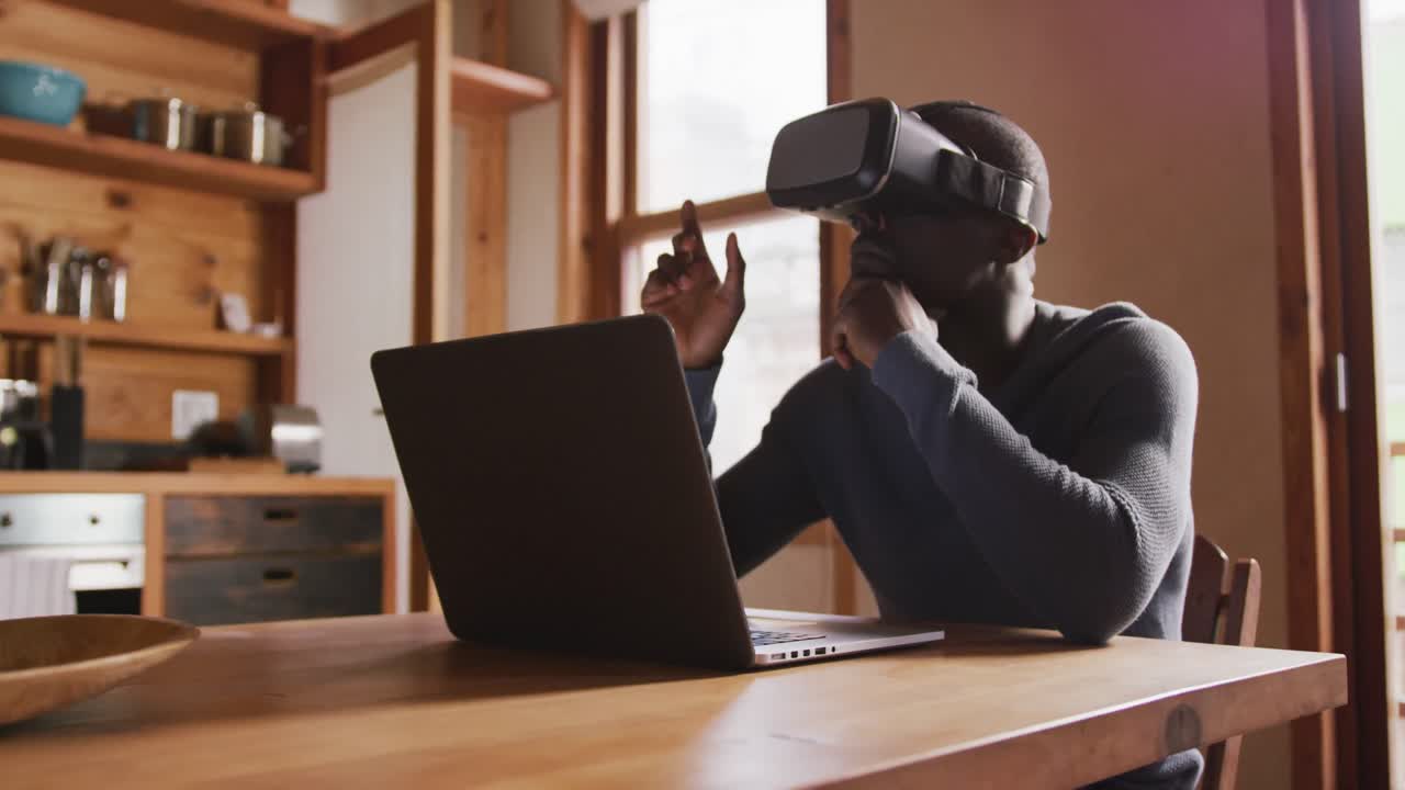 African American man wearing VR headset at home