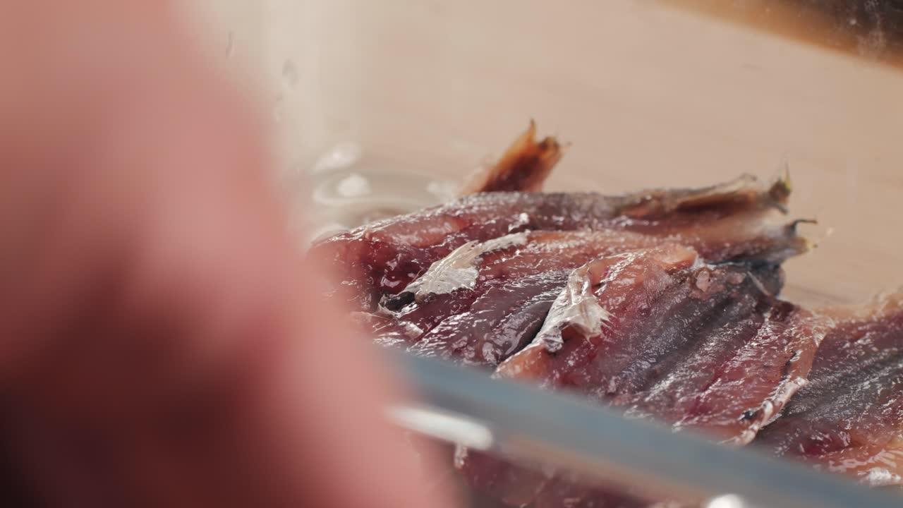 Fresh Sea sardines and Anchovy Fish and Mullus On Display On Ice On Market Store Shop. Seafood Fish Background, close up stand of small salty white fish.