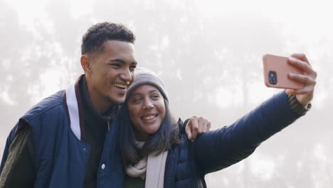 Selfie,-nature-and-couple-on-an-outdoor-camp