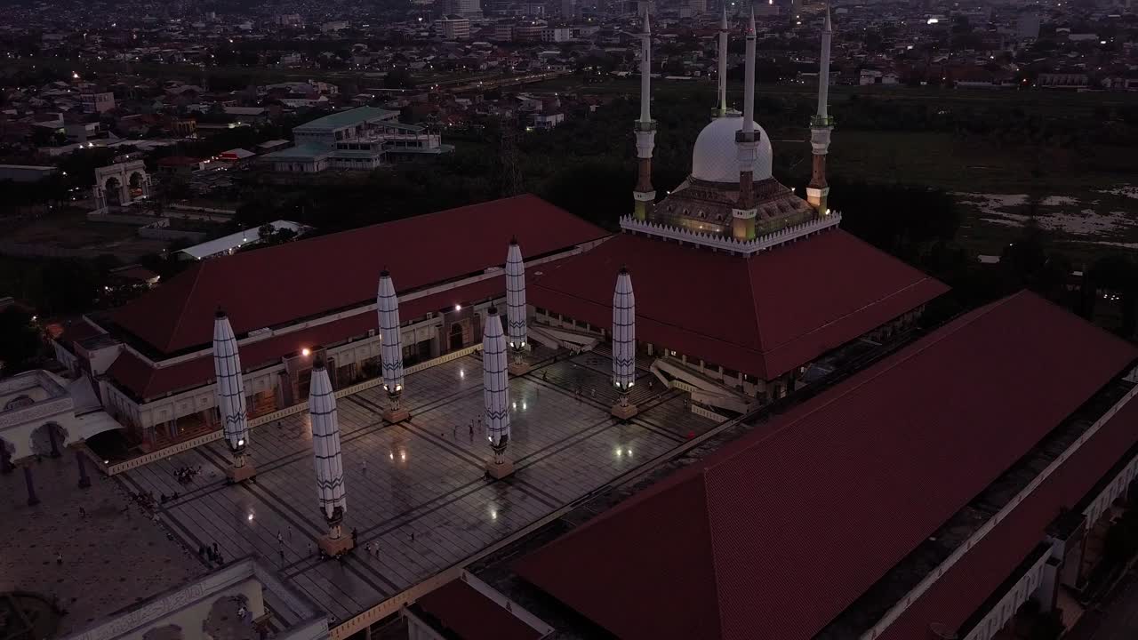 An aerial view of a Mosque building in Central Java with magnificent architecture and has a large umbrella in the yard