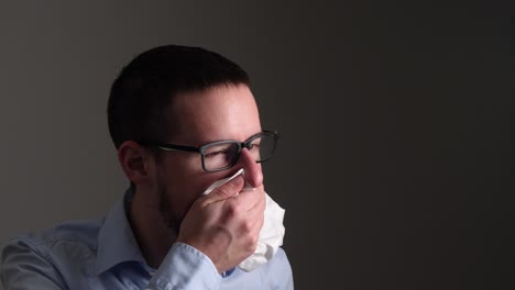 Young-man-coughs-vigorously-and-holds-a-paper-tissue-over-his-mouth-for-protection---Slow-Motion