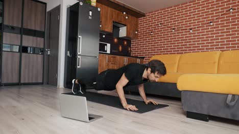 man doing push up at home live master class via laptop