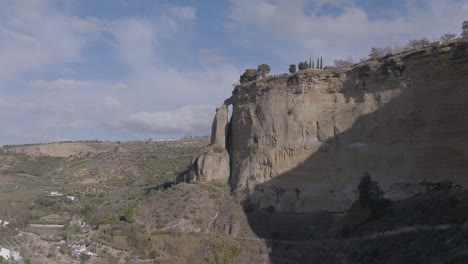 aerial approaches nearly detached limestone pillar below ronda, spain