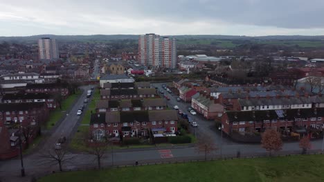 aerial above welsh flint housing estate north wales town property pan left