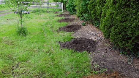 drilled holes for new fence in beautiful farmstead, tilting up view