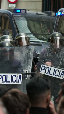 barcelona - spain - october 18 2019 : riot police clash with protestors at the general strike in via laietana, barcelona in vertical