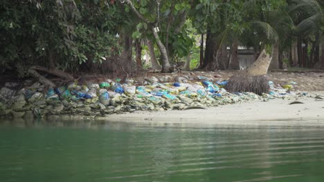 bags-of-rubbish-on-malaysia-seaside,-still-long-shot