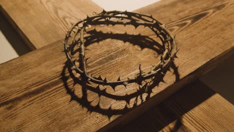 Religious-Concept-Shot-With-Crown-Of-Thorns-And-Wooden-Cross-In-Pool-Of-Light-2