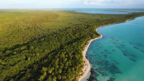 Aerial-view-overlooking-paradise-beaches-of-Punta-Cana,-sunset-in-Dominican-republic---pan,-drone-shot