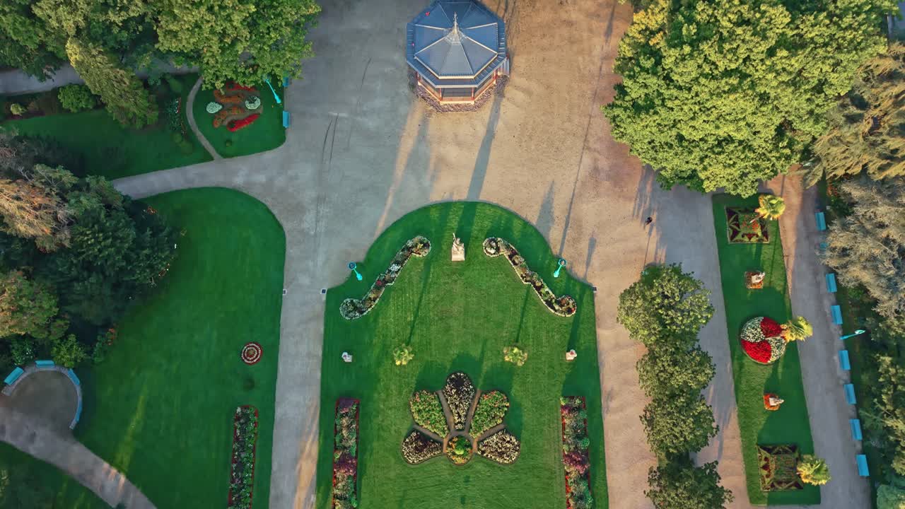 Drone shot in full top-down view flying over the Thabor Park fountain and symmetrical gardens in Rennes, France