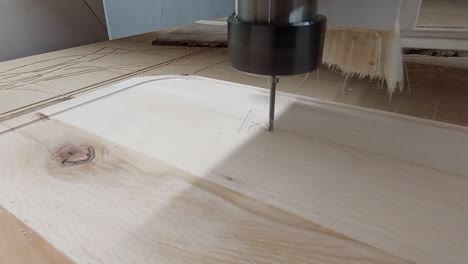 cnc router machine writing text to wooden steak cutting plate