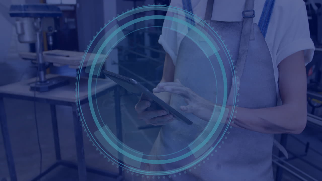 Person in workshop using tablet with digital interface overlay animation