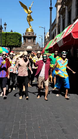 people in colorful costumes and masks in a mexican city street