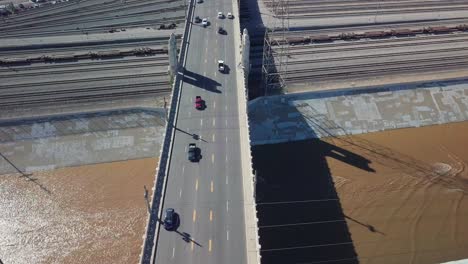 aerial tilt up from bridge over river to reveal downtown los angeles skyline