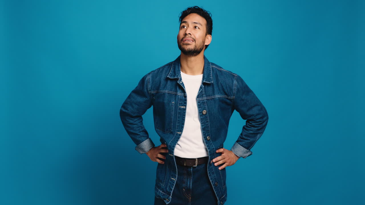 Man in denim jacket on blue background
