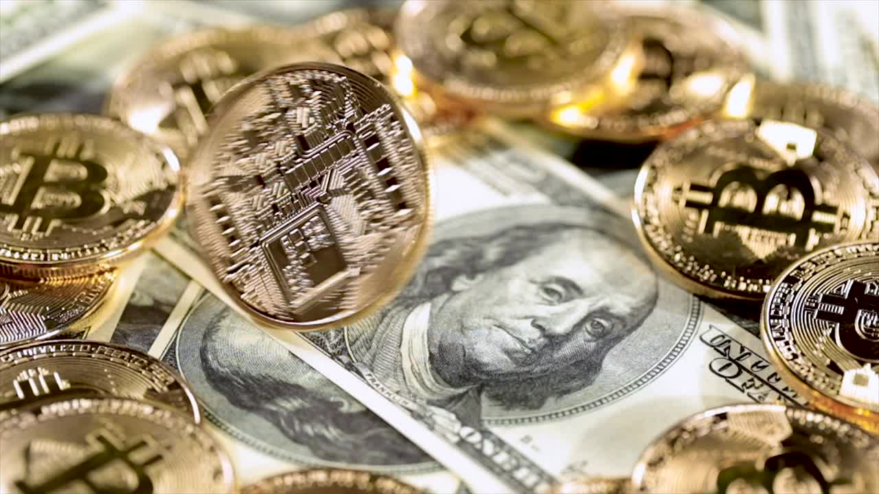 Gold Bit Coin BTC coins and dollar bills.