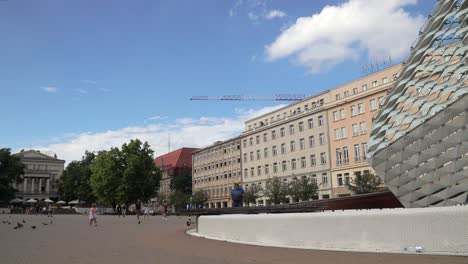 daytime timelapse of people walking at plac wolnosci square in poznan city center.