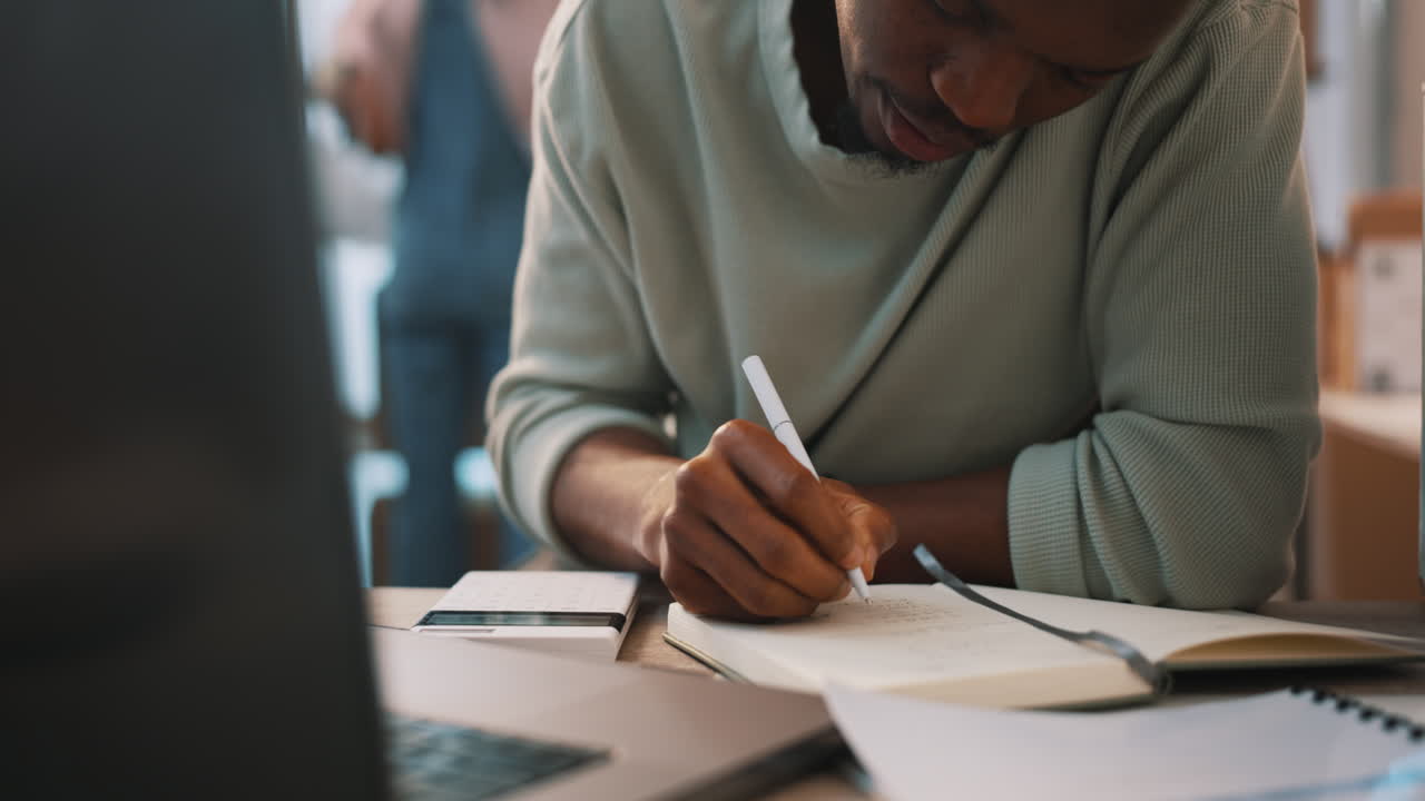 Man thinking, writing notes