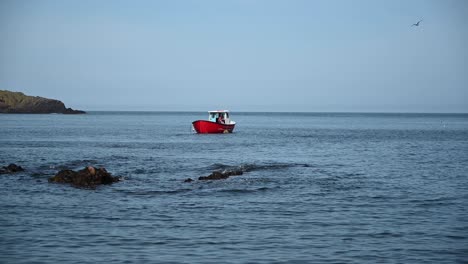 static shot of fisherman pulling out a crab pot from the sea