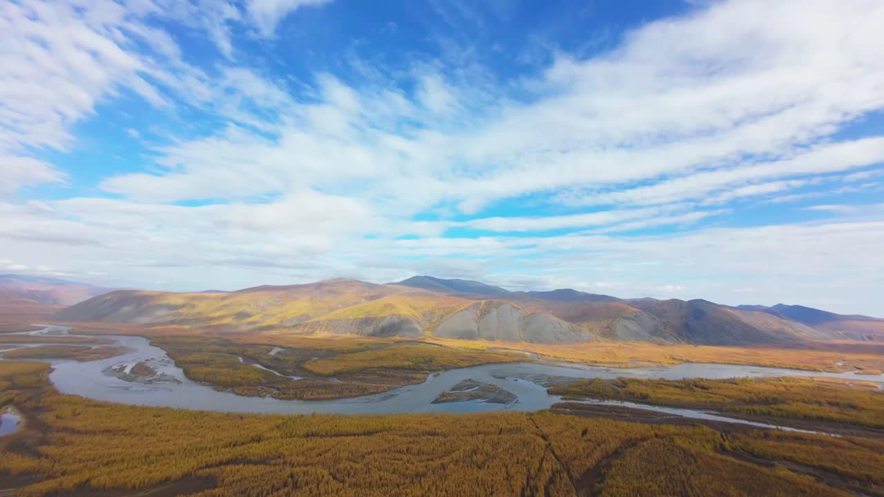 Experience a stunning aerial exploration through vibrant autumn hues as rivers carve through an enchanting landscape. Witness nature's artistry and the serene beauty of untouched wilderness.