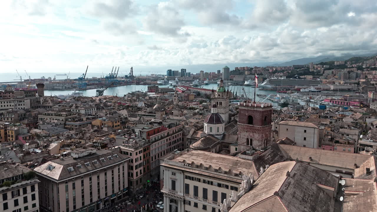 Grimaldina tower and Genoa red cross flag with view over Porto Antico, aerial