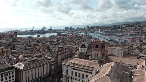 grimaldina tower and genoa red cross flag with view over porto antico, aerial