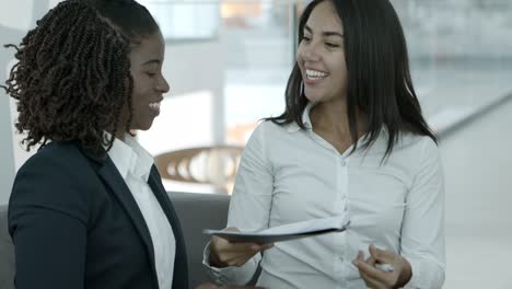 cheerful businesswomen shaking hands