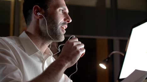 close up of businessman talking by smart phone at night