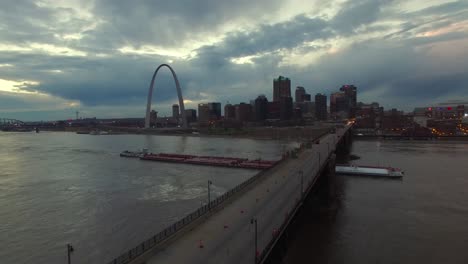 beautiful aerial over a mississippi river barge and bridge with the st louis missouri skyline background