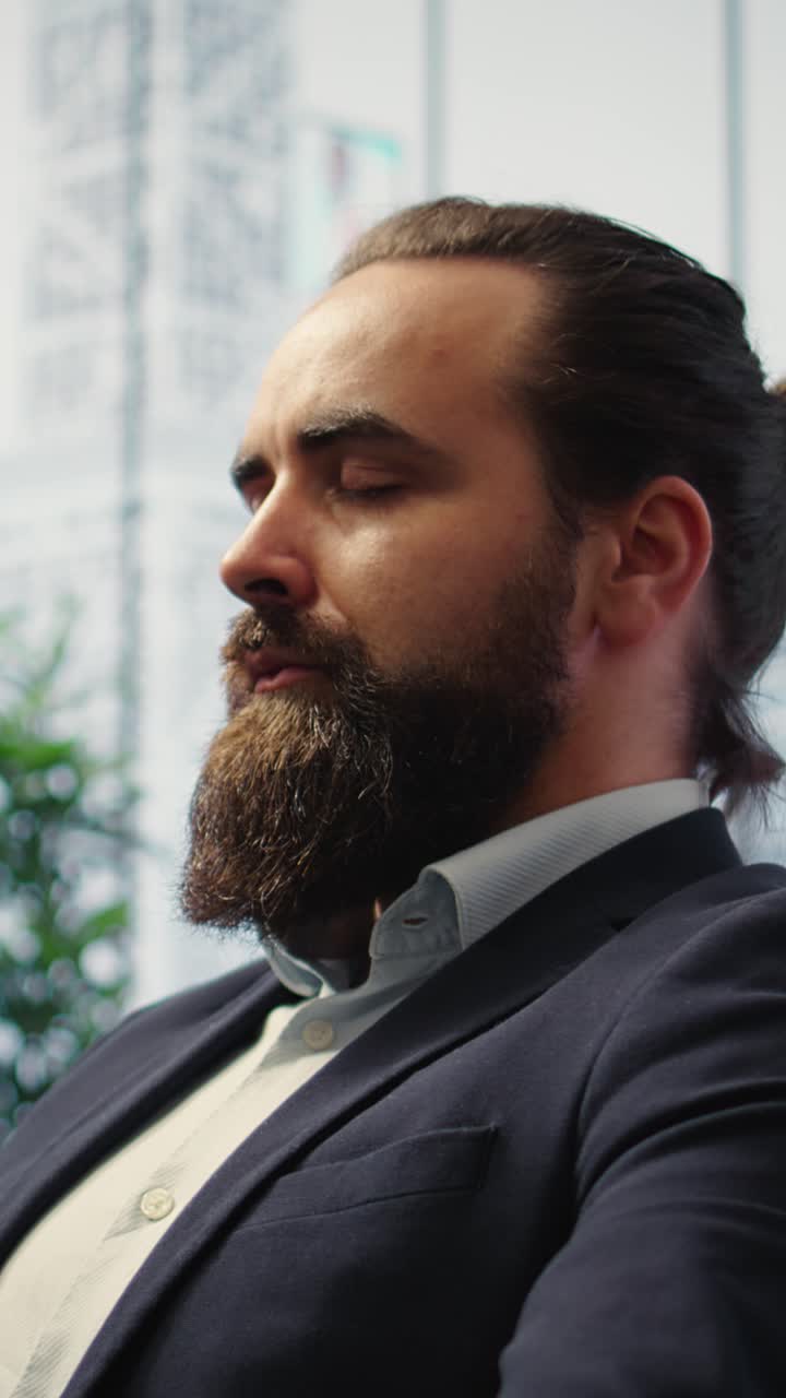 Vertical Video CEO leans back in his office chair engaging in a guided meditation session