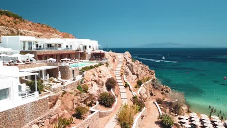 super paradise beach in mykonos greece aerial shot with a private resort and bay on a sunny day