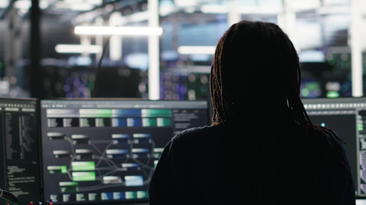 Data center engineer using algorithms to analyze datasets, putting on headphones