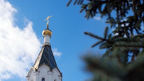 church tower with golden cross and dome