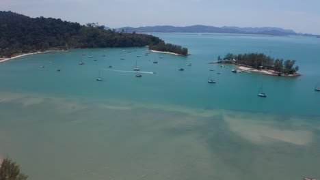 Aerial-footage-of-a-speed-boat-among-sailing-boats-in-the-sea