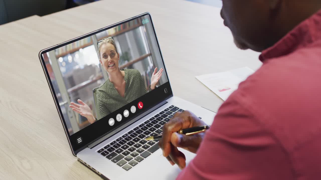 African american man using laptop for video call, with business colleague on screen