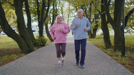 Athletic-fitness-senior-elderly-sport-runner-man-woman-training-cardio-workout-in-park-at-morning