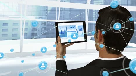 Animation-of-network-of-digital-icons-over-rear-view-of-caucasian-businessman-using-tablet-at-office
