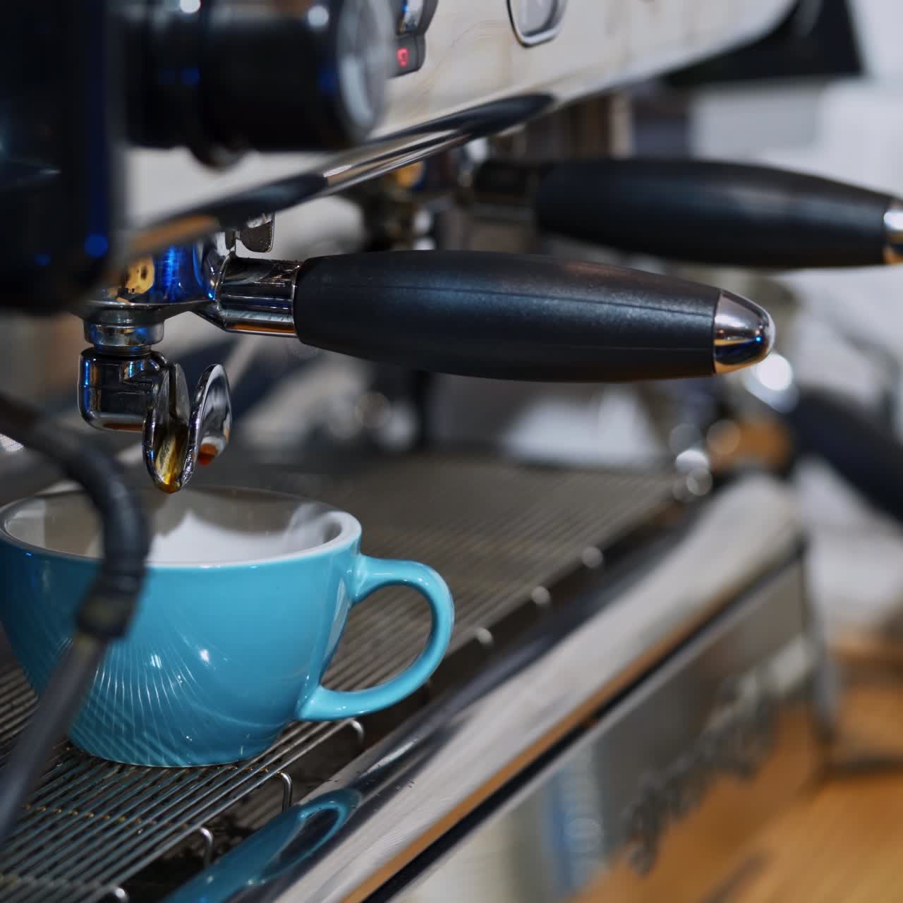 Making fresh coffee. Process of making espresso in a coffee machine. Woman takes the cup of hot coffee and shows it to camera.