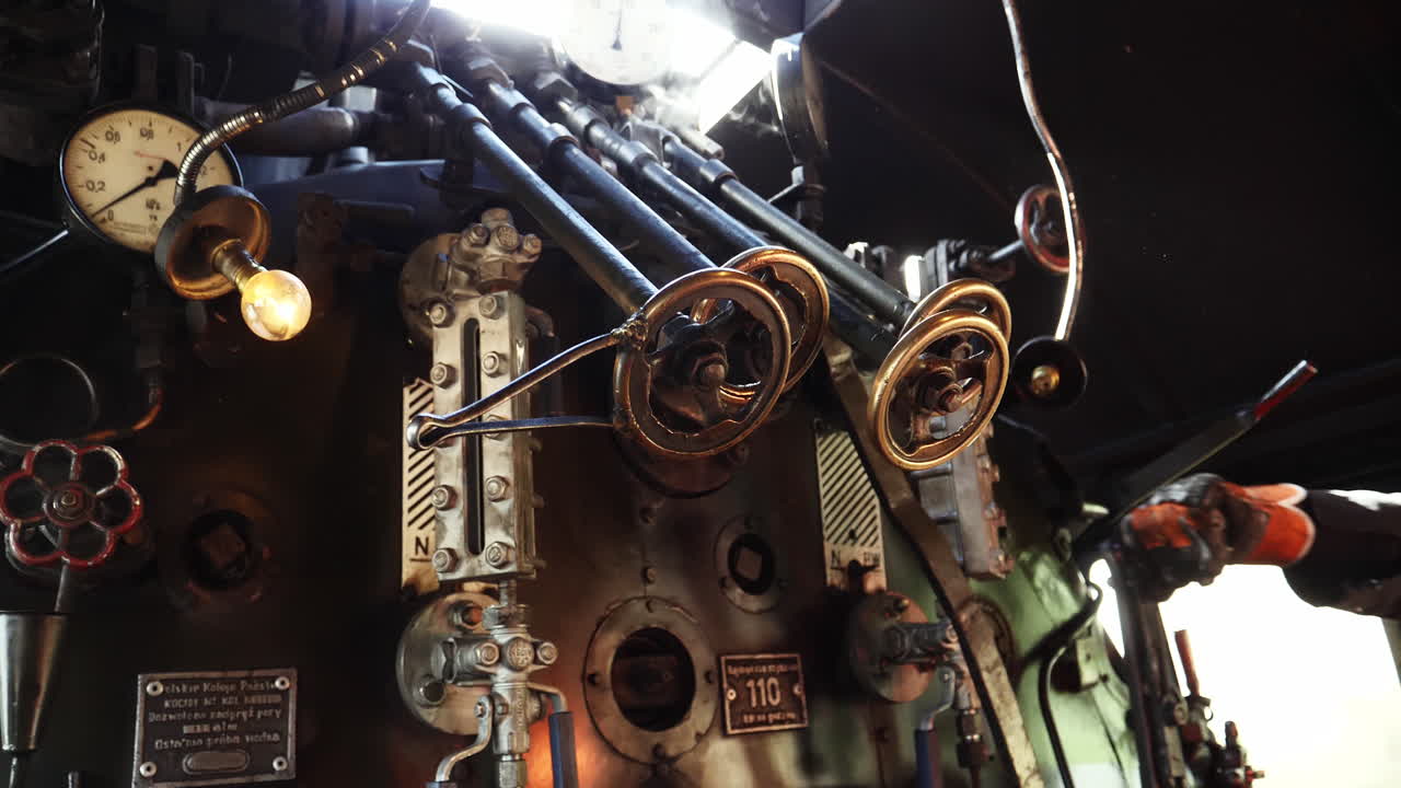 Close shot inside steam train locomotive, train driver control gears
