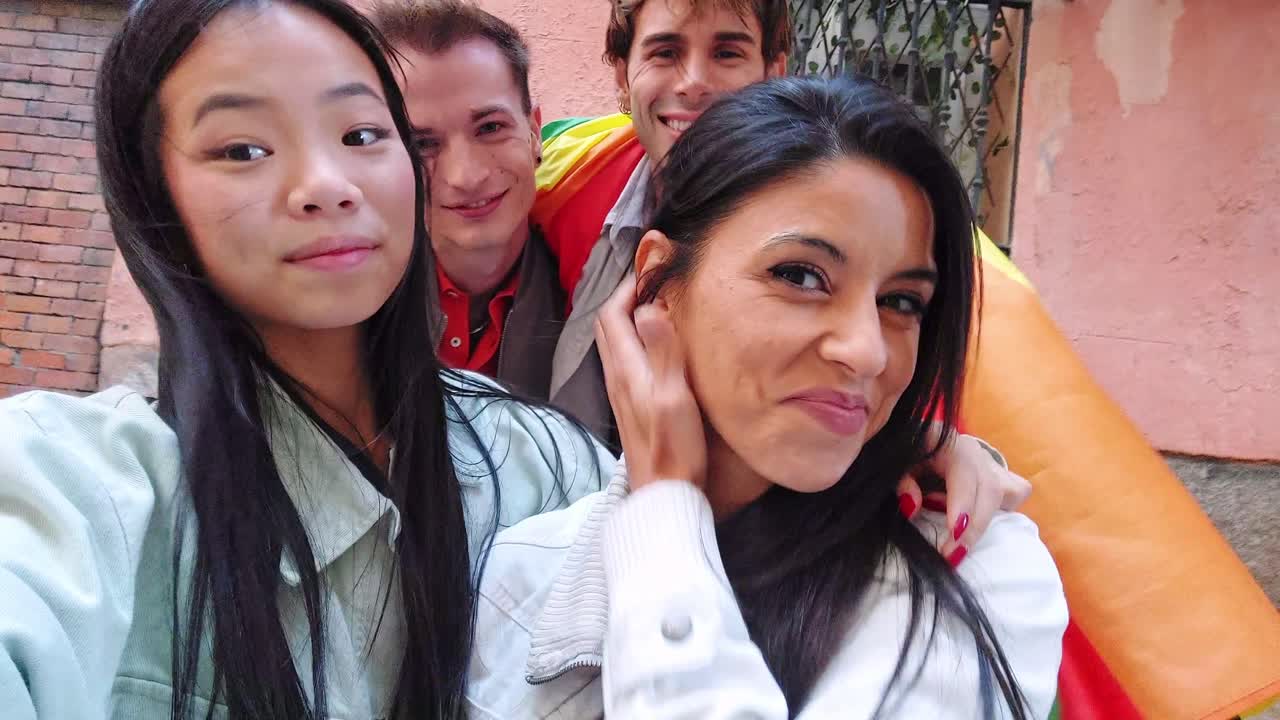 Happy Multi-Ethnic Friends Taking a Selfie with Rainbow Flag and Fan