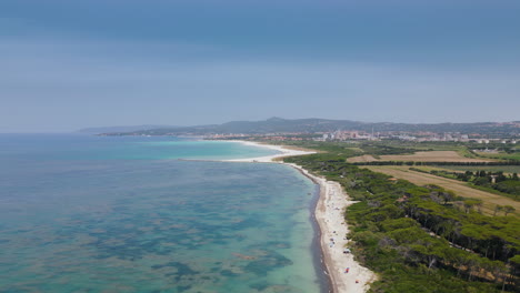 golden white sand on tuscan beach at midday beautiful ocean water, aerial