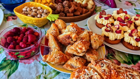 homemade pastries, cream desserts and cheese served on floral festive table