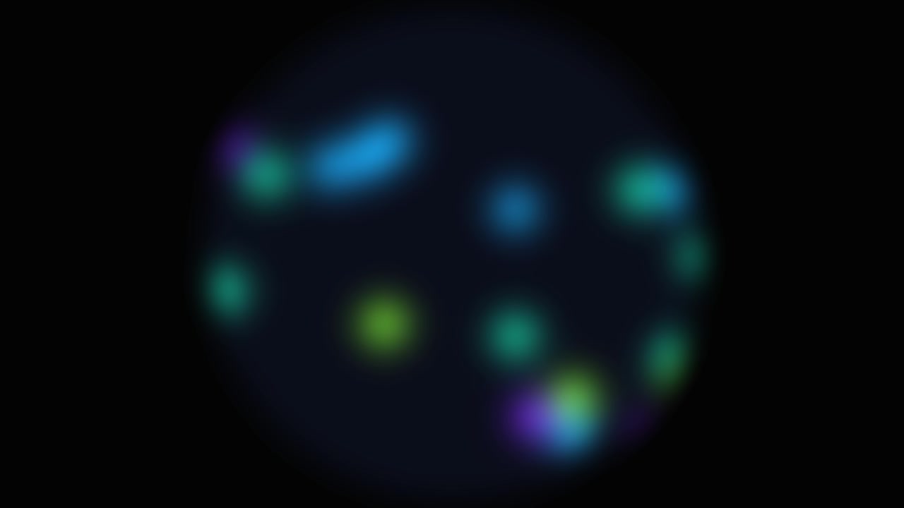 Sfondo colorato con campo di particelle arcobaleno e luci blu, verdi, viola e ciano delicatamente luminose disposte attorno a uno spazio centrale scuro.