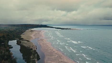 drone pan from small village to lake superior